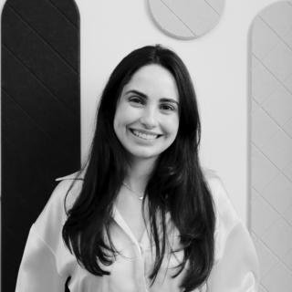 A black & white headshot photo of Ana Carolina Rocha, the Architectural Technologist Team Manager at MOY.